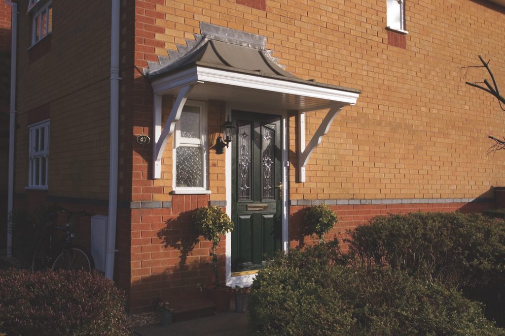 Bricked home with black entrance door