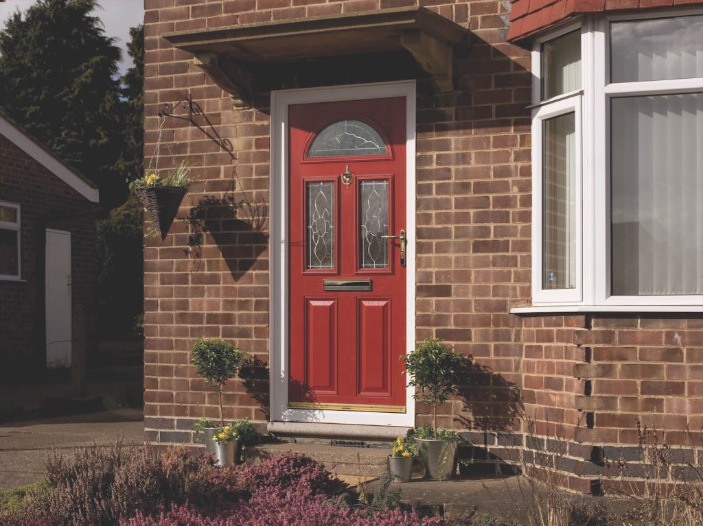 Red entrance door next to bay window