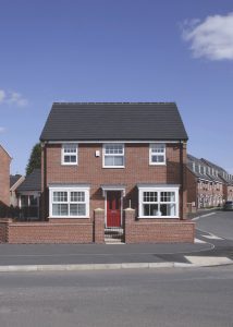 House with white double glazed uPVC windows and a red entrance door