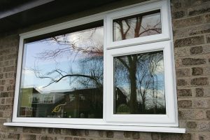 Exterior view of a white uPVC casement window, featuring a sleek design with a clean frame and clear glass, allowing natural light into the room.