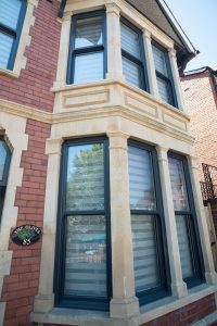 Double glazed Charisma vertical slider sash window in anthracite grey. The window features a modern design with sleek lines and traditional sash functionality, highlighting its stylish finish and energy-efficient glazing with no sign of condensation.