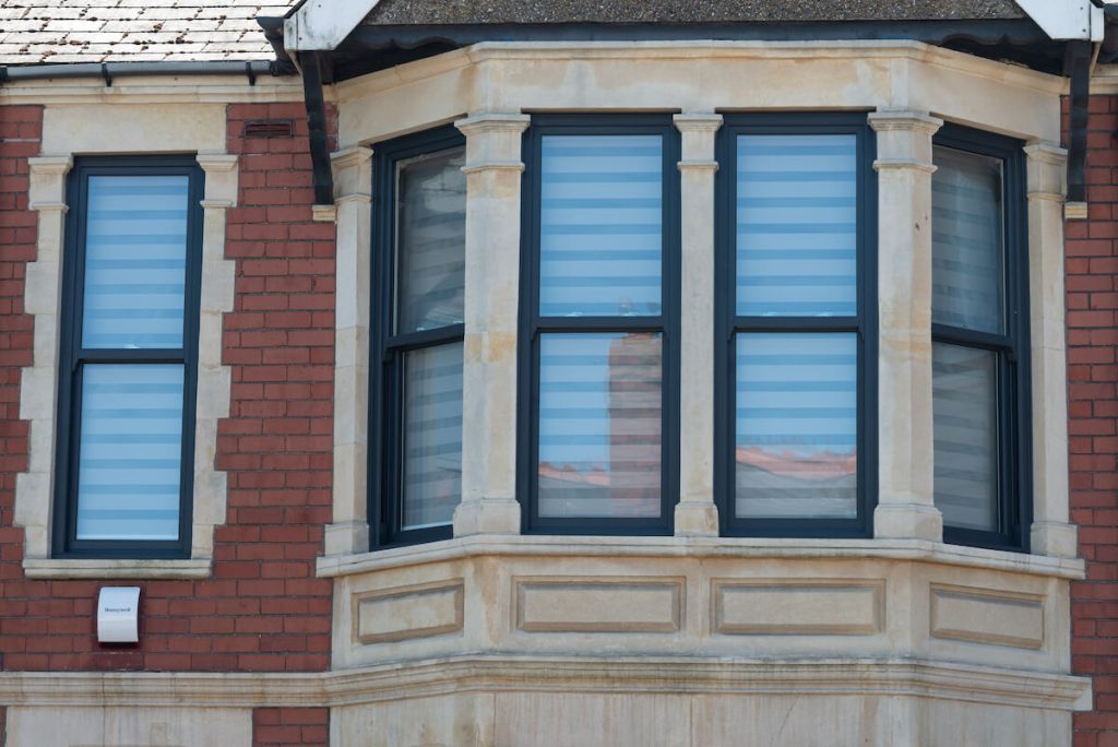 Close-up of a Charisma vertical slider sash window in anthracite grey. The window features a modern design with sleek lines and traditional sash functionality, highlighting its stylish finish and energy-efficient glazing.